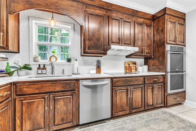 9021 Creek Side Trl, Hope Hull, AL 36043 - kitchen with stainless steel appliances, under cabinet range hood, light countertops, and ornamental molding