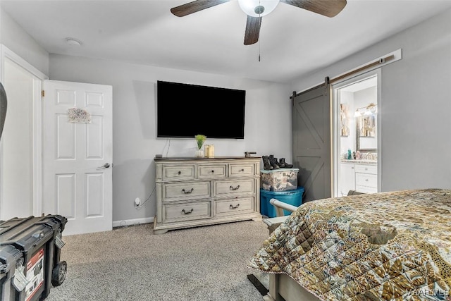 5777 Carriage Barn Ln, Montgomery, AL 36116 - carpeted bedroom with a barn door, a ceiling fan, and connected bathroom