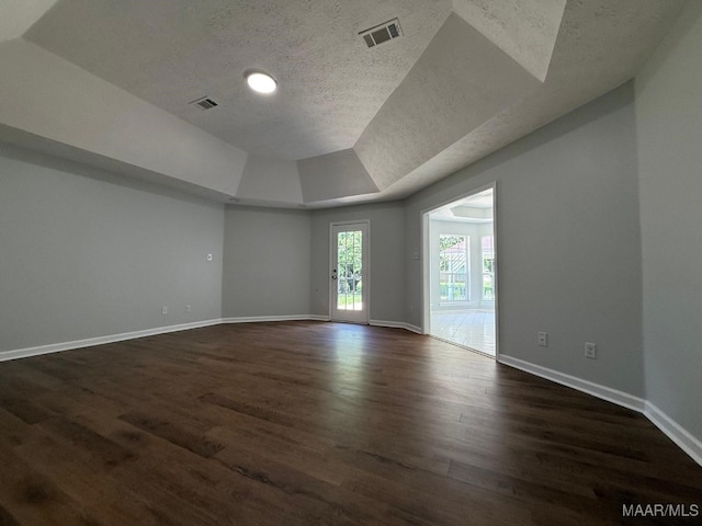 6524 Foxleigh Ct, Montgomery, AL 36116 - unfurnished room with a textured ceiling, dark wood-type flooring, and vaulted ceiling