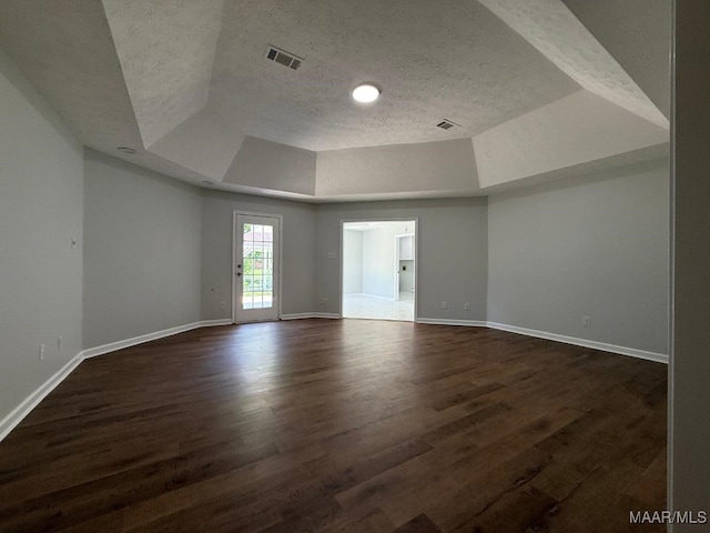 6524 Foxleigh Ct, Montgomery, AL 36116 - unfurnished room featuring a textured ceiling, dark wood finished floors, and a tray ceiling