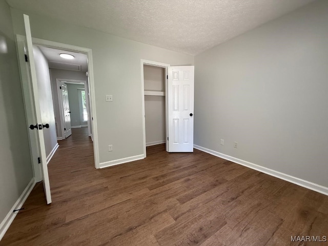 6524 Foxleigh Ct, Montgomery, AL 36116 - unfurnished bedroom featuring dark wood-style floors, a textured ceiling, and a closet