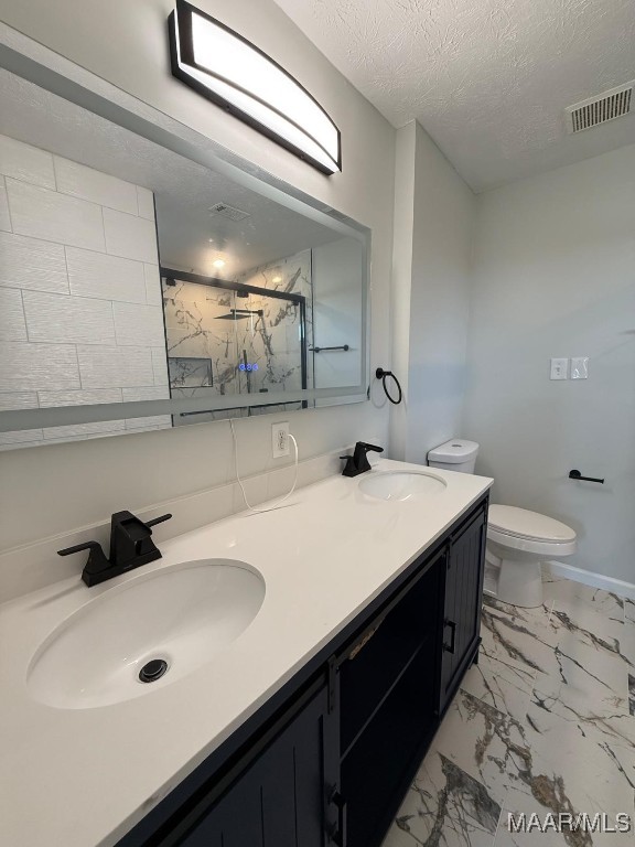 6524 Foxleigh Ct, Montgomery, AL 36116 - full bath featuring a marble finish shower, double vanity, marble finish flooring, and a textured ceiling