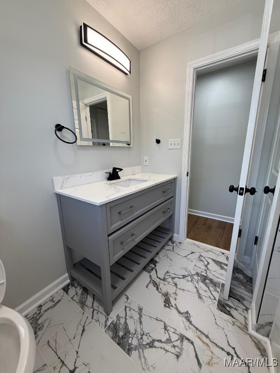 6524 Foxleigh Ct, Montgomery, AL 36116 - bathroom with marble finish floors, vanity, and a textured ceiling