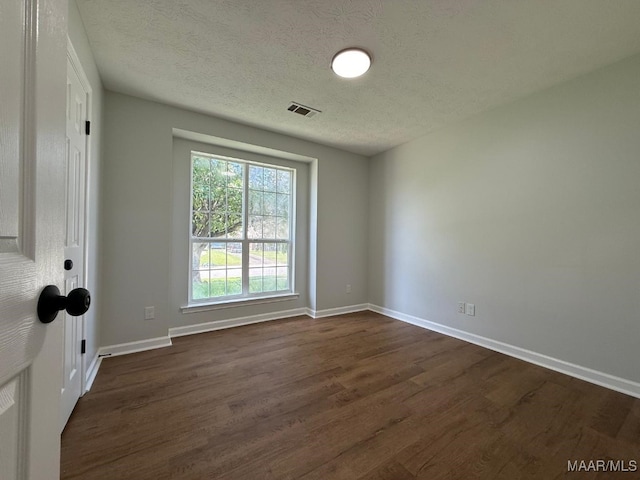 6524 Foxleigh Ct, Montgomery, AL 36116 - empty room with dark wood-style floors and a textured ceiling