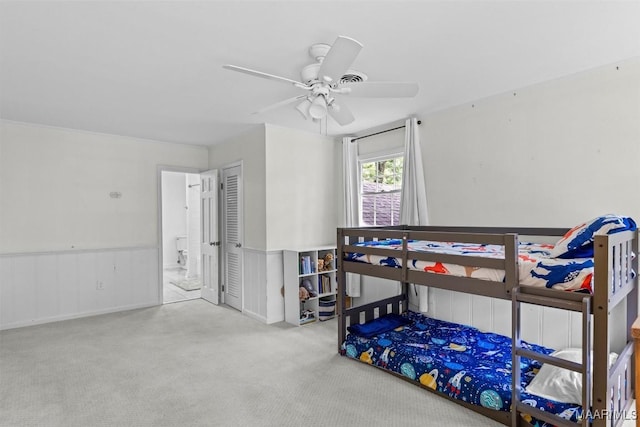 1613 Croom Dr, Montgomery, AL 36106 - carpeted bedroom featuring ensuite bath, ceiling fan, and wainscoting