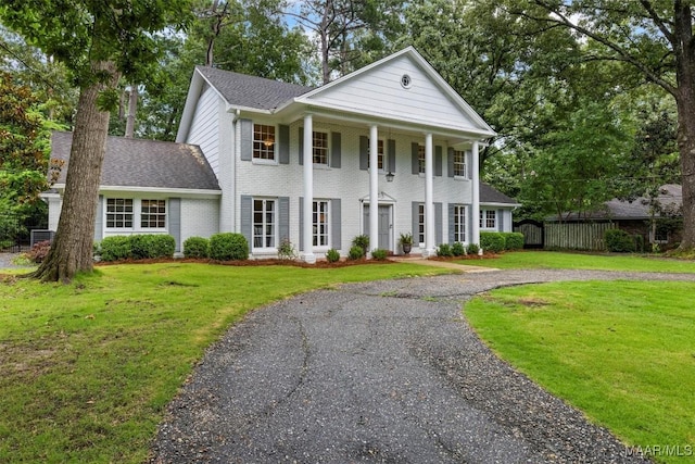 1613 Croom Dr, Montgomery, AL 36106 - neoclassical home featuring curved driveway, brick siding, roof with shingles, and a porch