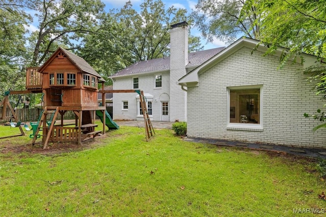 1613 Croom Dr, Montgomery, AL 36106 - rear view of property featuring a playground, brick siding, and a chimney