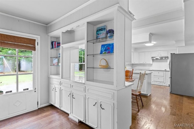 1613 Croom Dr, Montgomery, AL 36106 - kitchen with freestanding refrigerator, ornamental molding, white cabinetry, dark wood-style floors, and light countertops