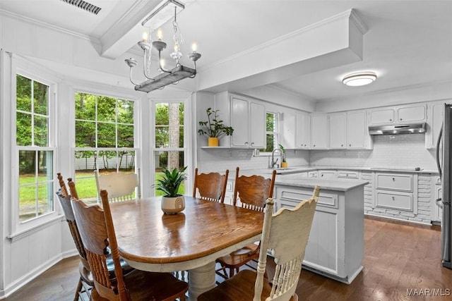 1613 Croom Dr, Montgomery, AL 36106 - dining space with dark wood finished floors, a chandelier, and ornamental molding