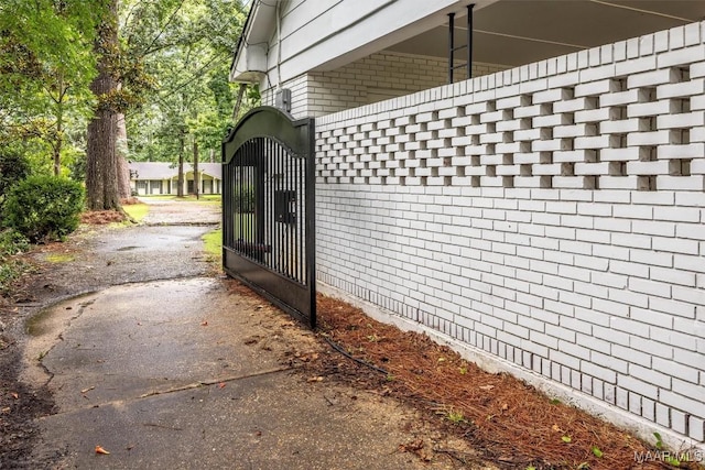 1613 Croom Dr, Montgomery, AL 36106 - view of home's exterior with brick siding, a gate, and driveway