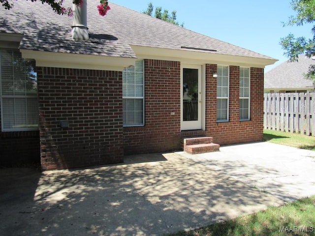 9467 Greythorne Way, Montgomery, AL 36117 - back of house with entry steps, a shingled roof, a patio area, and brick siding