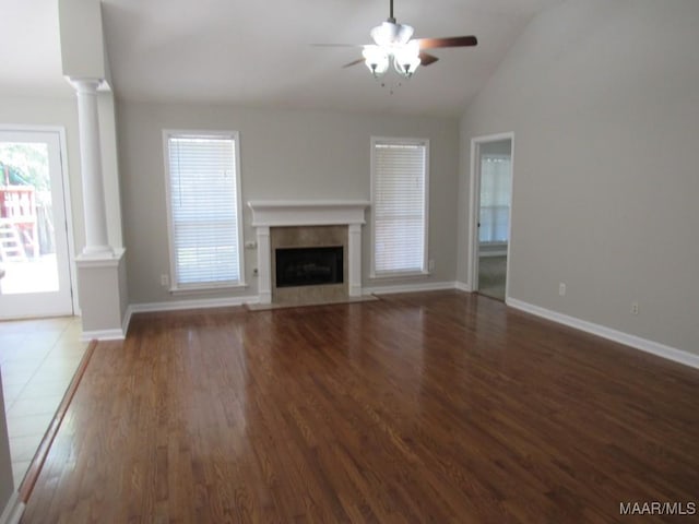 9467 Greythorne Way, Montgomery, AL 36117 - unfurnished living room featuring decorative columns, a ceiling fan, wood finished floors, a fireplace with flush hearth, and vaulted ceiling
