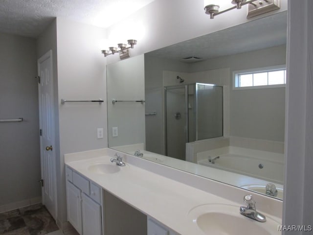 9467 Greythorne Way, Montgomery, AL 36117 - full bathroom featuring a stall shower, double vanity, a textured ceiling, and a bath