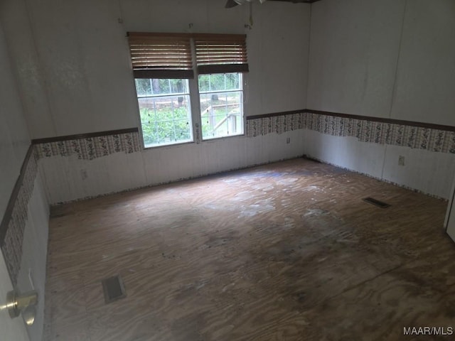 3149 Blackwell Rd, Highland Home, AL 36041 - unfurnished room featuring wainscoting and a ceiling fan