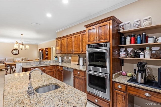 760 Winding Wood Dr, Wetumpka, AL 36093 - kitchen featuring appliances with stainless steel finishes, ornamental molding, open shelves, a chandelier, and light stone counters