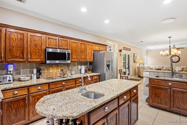 760 Winding Wood Dr, Wetumpka, AL 36093 - kitchen featuring stainless steel appliances, decorative backsplash, open floor plan, an island with sink, and a chandelier