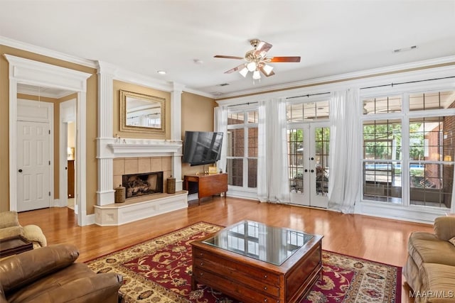 760 Winding Wood Dr, Wetumpka, AL 36093 - living room featuring a ceiling fan, crown molding, a fireplace, wood finished floors, and french doors