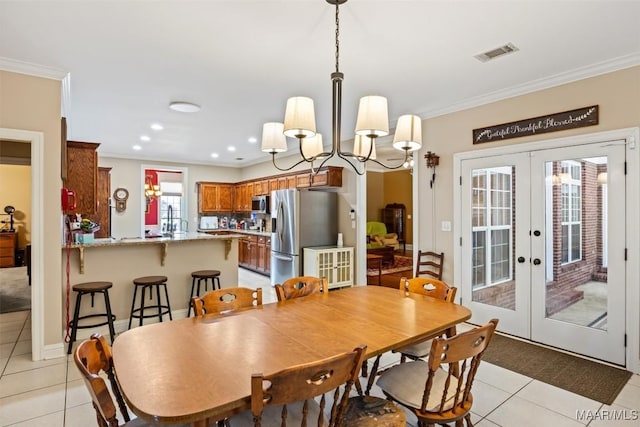 760 Winding Wood Dr, Wetumpka, AL 36093 - dining space featuring light tile patterned flooring, crown molding, french doors, a chandelier, and recessed lighting