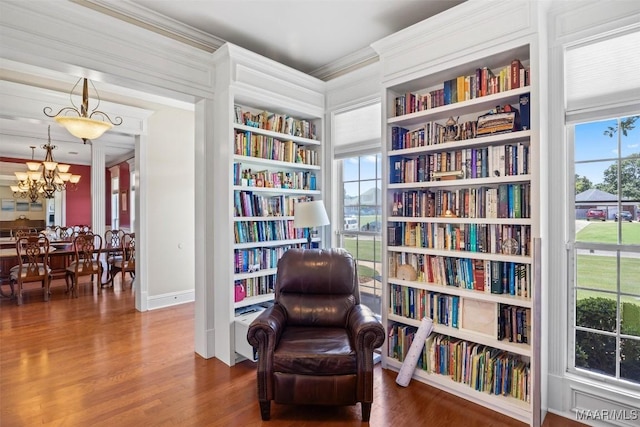 760 Winding Wood Dr, Wetumpka, AL 36093 - sitting room featuring crown molding, wood finished floors, a chandelier, built in features, and wall of books