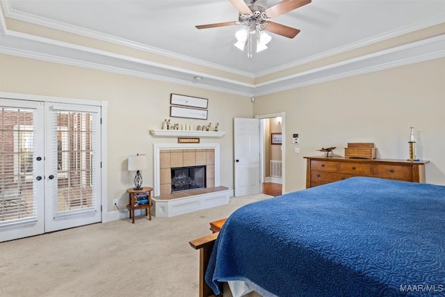 760 Winding Wood Dr, Wetumpka, AL 36093 - carpeted bedroom with access to outside, crown molding, french doors, a tray ceiling, and a tiled fireplace
