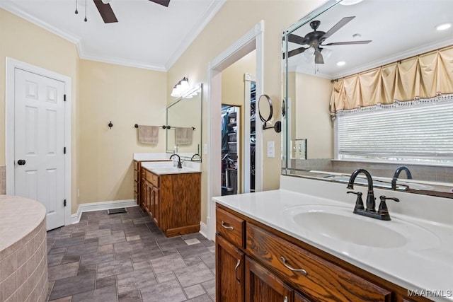 760 Winding Wood Dr, Wetumpka, AL 36093 - bathroom featuring a ceiling fan, stone finish floors, ornamental molding, two vanities, and a closet