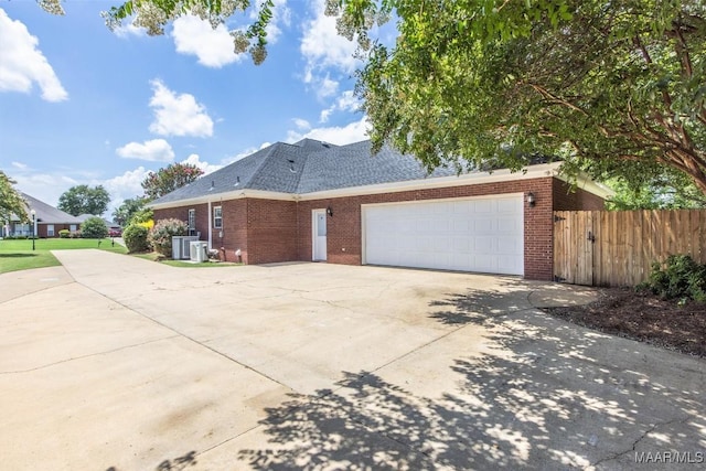 760 Winding Wood Dr, Wetumpka, AL 36093 - view of home's exterior featuring brick siding, driveway, an attached garage, and roof with shingles