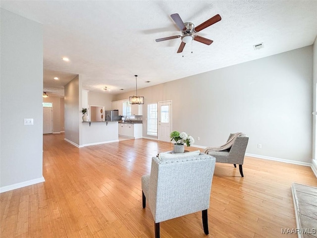 9642 Greythorne Way, Montgomery, AL 36117 - living room with a ceiling fan, light wood finished floors, recessed lighting, and a chandelier