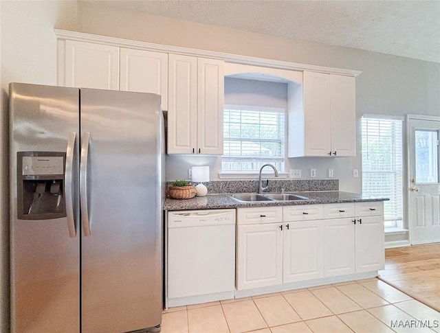 9642 Greythorne Way, Montgomery, AL 36117 - kitchen featuring stainless steel refrigerator with ice dispenser, dishwasher, white cabinets, light tile patterned floors, and dark stone counters