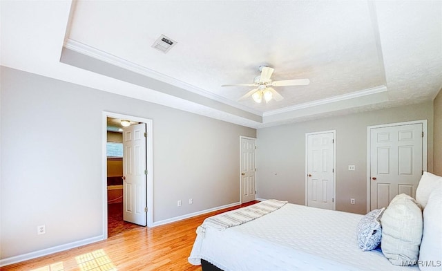 9642 Greythorne Way, Montgomery, AL 36117 - bedroom with a raised ceiling, light wood finished floors, crown molding, and a ceiling fan