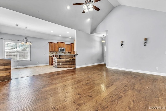 2285 Gathering Way, Prattville, AL 36066 - unfurnished living room with ceiling fan, light wood-type flooring, a chandelier, recessed lighting, and high vaulted ceiling