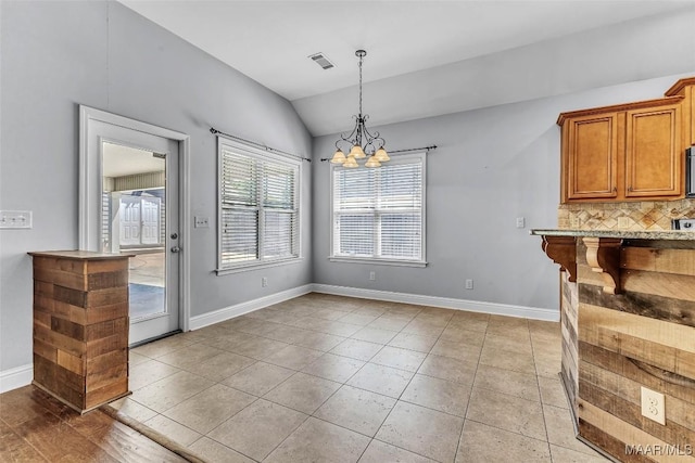 2285 Gathering Way, Prattville, AL 36066 - unfurnished dining area featuring vaulted ceiling, a chandelier, and light tile patterned flooring