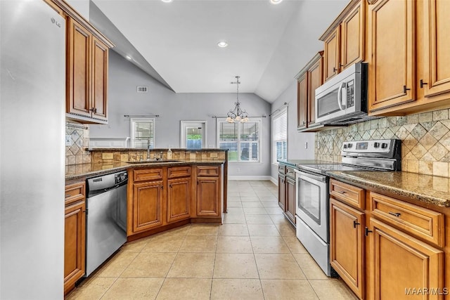 2285 Gathering Way, Prattville, AL 36066 - kitchen with vaulted ceiling, appliances with stainless steel finishes, tasteful backsplash, light tile patterned floors, and a chandelier