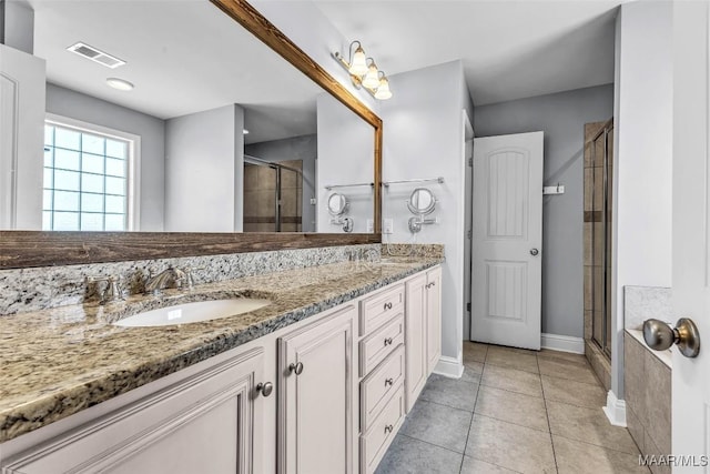 2285 Gathering Way, Prattville, AL 36066 - bathroom with double vanity, a shower stall, and tile patterned flooring