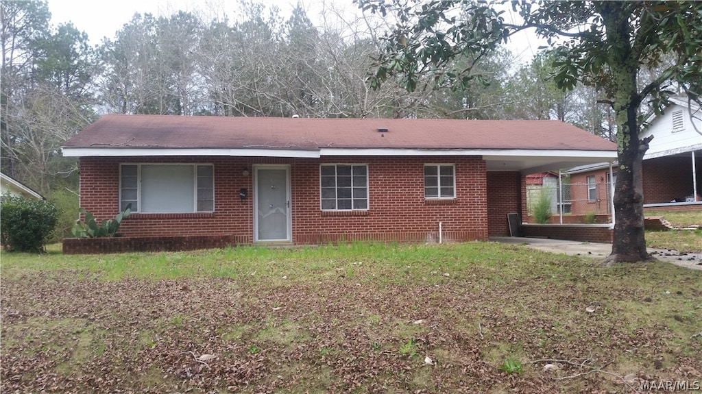 single story home featuring a front yard and a carport