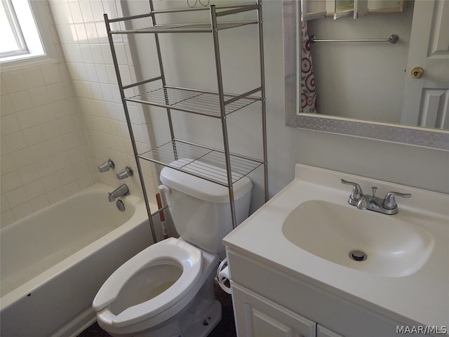 full bathroom featuring toilet, vanity, and tiled shower / bath