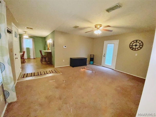 interior space with light colored carpet and ceiling fan