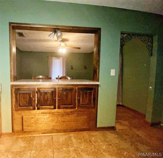 kitchen featuring light tile floors and ceiling fan