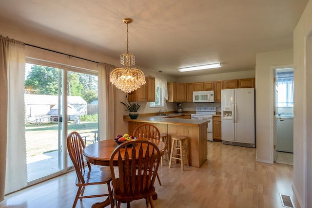 772 Cedar St, Whitefish, MT 59937 - dining room featuring light wood finished floors, a chandelier, and washer / clothes dryer