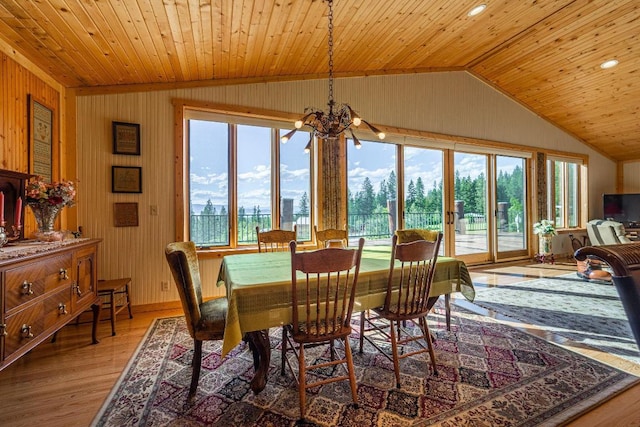 dining room featuring a chandelier, vaulted ceiling, wooden ceiling, and hardwood / wood-style floors