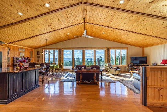 interior space featuring light hardwood / wood-style flooring, wood ceiling, ceiling fan with notable chandelier, and lofted ceiling