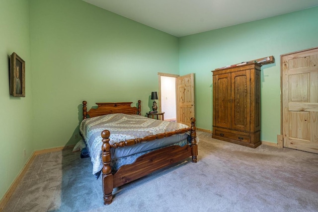 carpeted bedroom with a towering ceiling