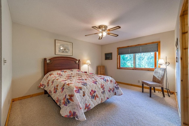 bedroom with light carpet, a textured ceiling, and ceiling fan