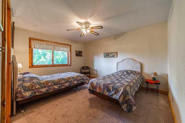 carpeted bedroom featuring a textured ceiling and ceiling fan