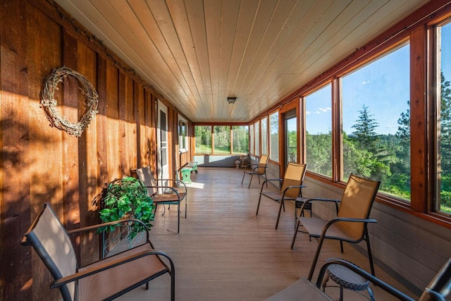 sunroom / solarium with plenty of natural light and wood ceiling