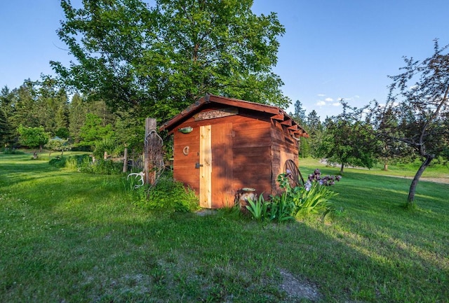 view of outdoor structure featuring a lawn