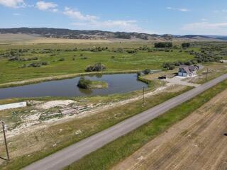 birds eye view of property featuring a rural view and a water view