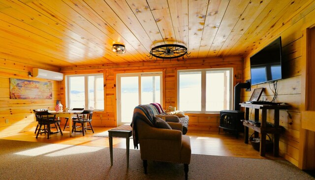 carpeted living room featuring a wall unit AC, wood ceiling, wooden walls, and a wood stove