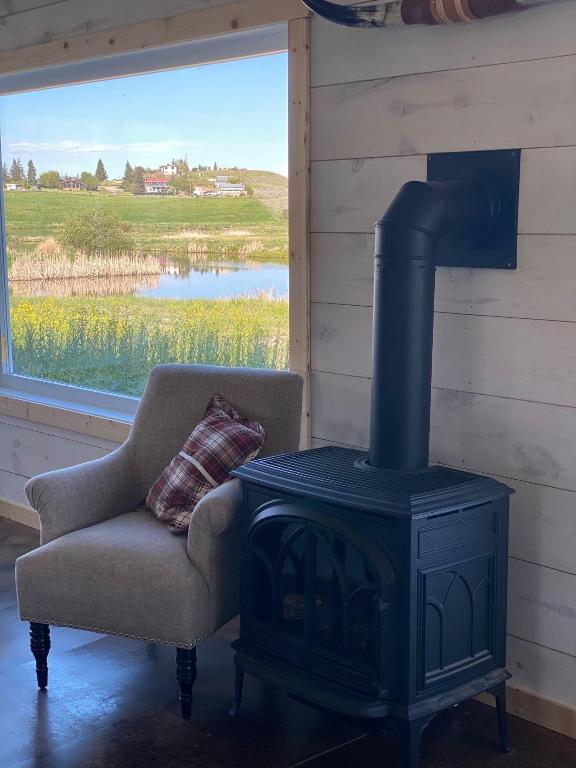 room details with a wood stove, a water view, and concrete floors