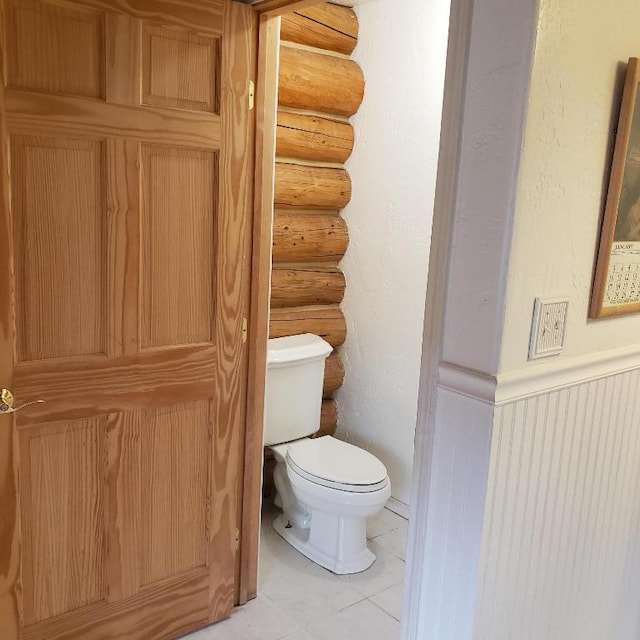 bathroom featuring toilet and tile flooring