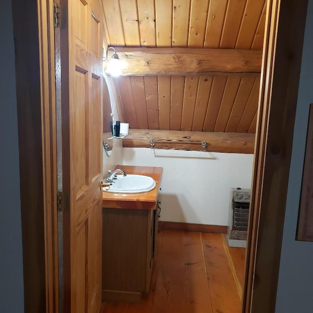 bathroom featuring hardwood / wood-style flooring, wood ceiling, and vanity